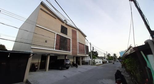 a building with a car parked next to a street at Clark-Pad Inn, Angeles City in Angeles