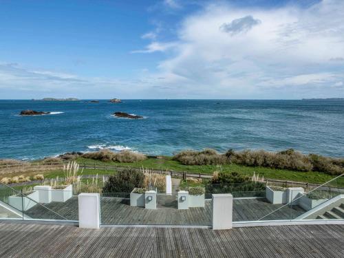 a view of the ocean from a deck at Emeria Dinard Thalasso Spa in Dinard