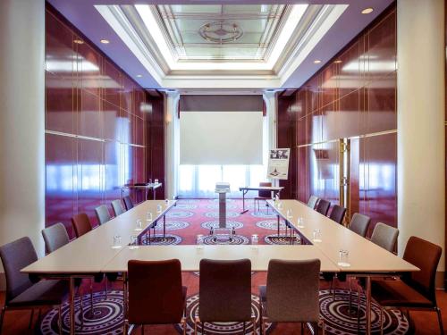 a conference room with a long table and chairs at Mercure Lyon Centre Château Perrache in Lyon