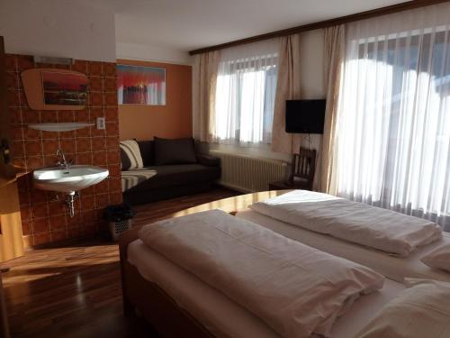 a bedroom with two beds and a living room at Ferienhaus Teigi in Wagrain
