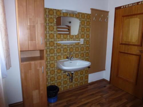 a bathroom with a sink and a mirror at Ferienhaus Teigi in Wagrain