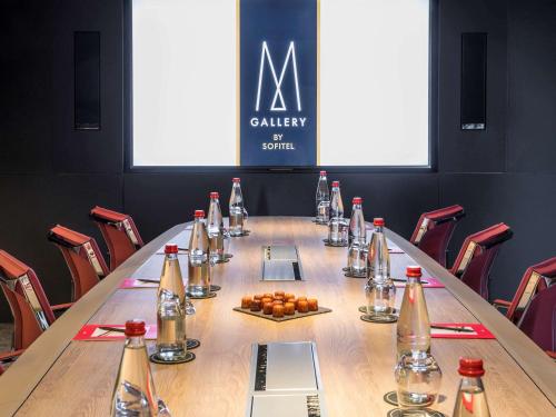 a conference room with a long table with bottles on it at Cabot Hotel Bordeaux - MGallery Collection in Le Pian-Médoc