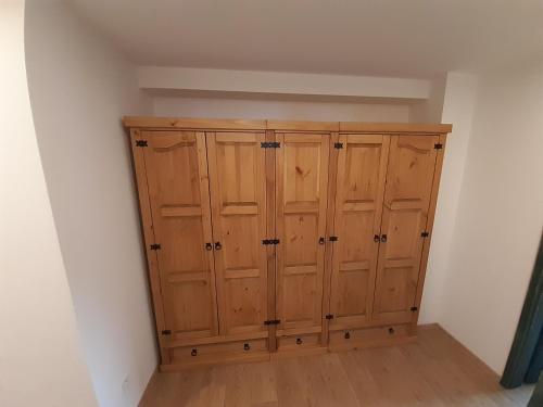 a wooden cabinet in a corner of a room at Apartmány pod Mariánskými schody in Albrechtice v Jizerských horách