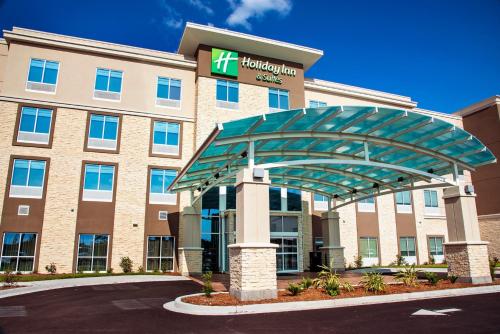 an office building with a sign for a hotel at Holiday Inn & Suites - Savannah Airport - Pooler, an IHG Hotel in Savannah