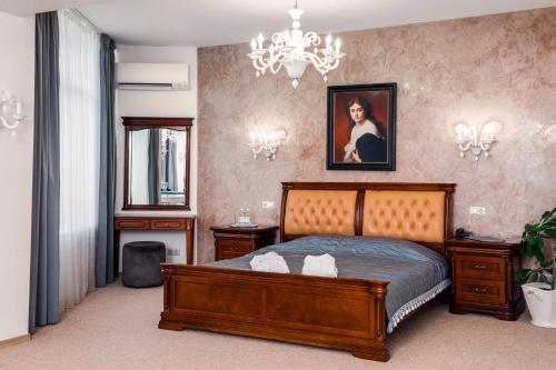 a bedroom with a bed and a chandelier at Hotel Kyiv in Kyiv