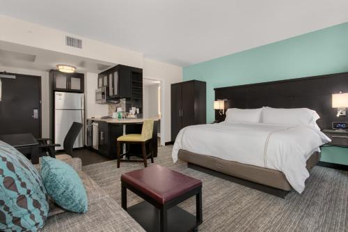 a large hotel room with a bed and a kitchen at Staybridge Suites Seattle - South Lake Union, an IHG Hotel in Seattle