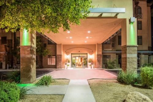 an empty lobby of a building with green columns at Holiday Inn & Suites Goodyear - West Phoenix Area by IHG in Goodyear