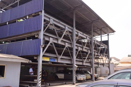 a building under construction with cars parked in it at GolfView Suites & Conference Center in Ikeja