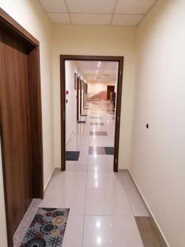an empty corridor in a building with a hallway at Hotel Lago Peshtera in Peshtera