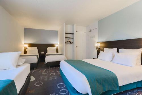 a hotel room with two beds and a room with two at Kyriad Lille Gare - Grand Palais in Lille