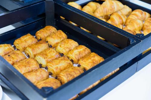 a bunch of donuts are in a box at Kyriad Lille Gare - Grand Palais in Lille