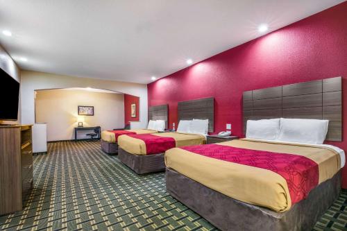 a hotel room with two beds and a flat screen tv at Econo Lodge Inn & Suites Horn Lake in Horn Lake