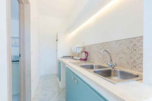 a kitchen with a sink and a counter top at Villa Nettuno in Torre Santa Sabina