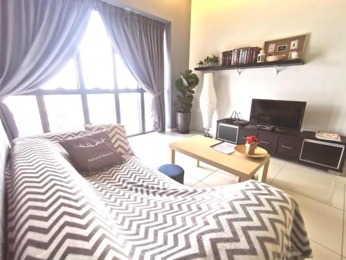 a bedroom with a bed and a desk and a window at CoZy Suite @ PJ & Sunway(2 Bedroom) in Petaling Jaya