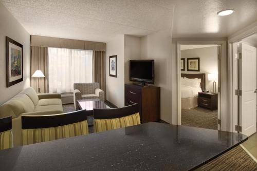 a living room filled with furniture and a large window at Holiday Inn Scottsdale North- Airpark, an IHG Hotel in Scottsdale