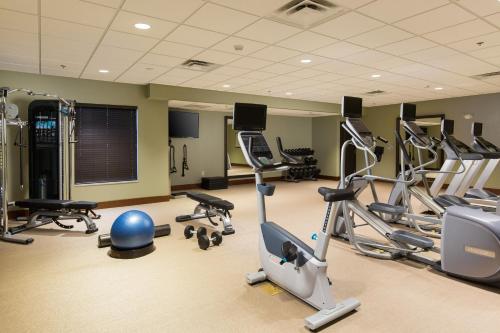 a gym with several treadmills and exercise bikes at Staybridge Suites Toledo/Maumee by IHG in Maumee