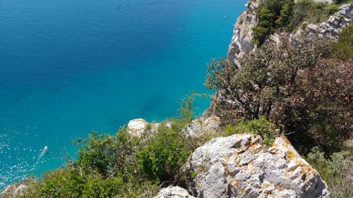 a view of the blue ocean from a mountain at Residence Le Dune Club in Varigotti