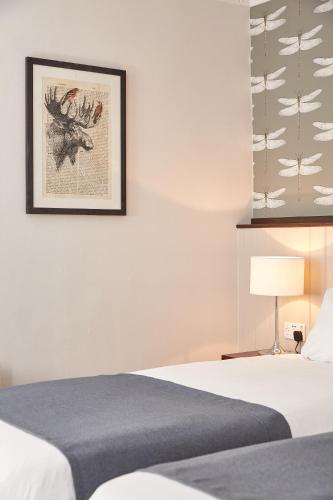 a bedroom with a bed and a picture on the wall at Corner House Inn by Greene King Inns in Newcastle upon Tyne