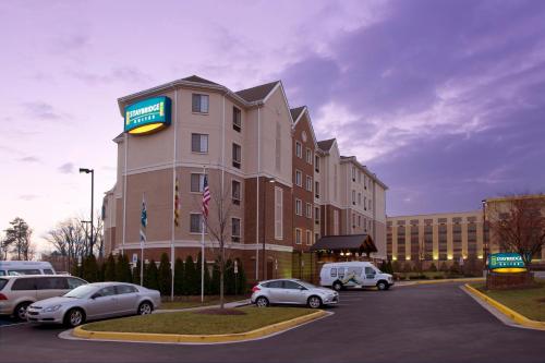a hotel with cars parked in a parking lot at Staybridge Suites Baltimore BWI Airport, an IHG Hotel in Linthicum Heights