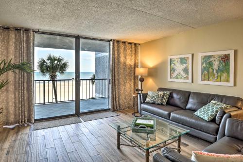 a living room with a couch and a view of the ocean at Chic Myrtle Beach Seaside Escape with Pool Access! in Myrtle Beach