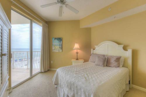a bedroom with a bed and a balcony at Dunes of Seagrove Condos in Santa Rosa Beach