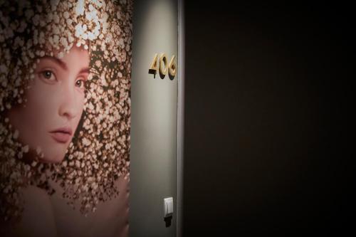 a door with a picture of a woman on the wall at L&H La Latina Selection in Madrid