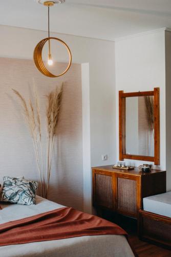 a bedroom with a bed and a dresser and a mirror at Sealake View in Mesolongion