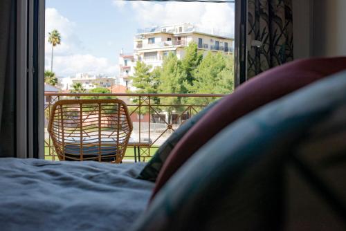 a bedroom with a bed and a view of a balcony at Sealake View in Mesolongion