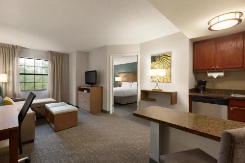 a hotel room with a bed and a living room at Staybridge Suites Tampa East- Brandon, an IHG Hotel in Tampa