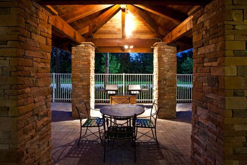 a patio with a table and chairs under a wooden ceiling at Staybridge Suites Tampa East- Brandon by IHG in Tampa