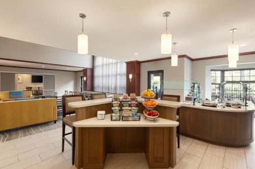 a hotel lobby with a breakfast bar and a cafeteria at Staybridge Suites Tampa East- Brandon by IHG in Tampa