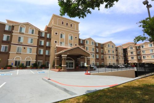 a building with a red hose in front of it at Staybridge Suites Silicon Valley - Milpitas by IHG in Milpitas