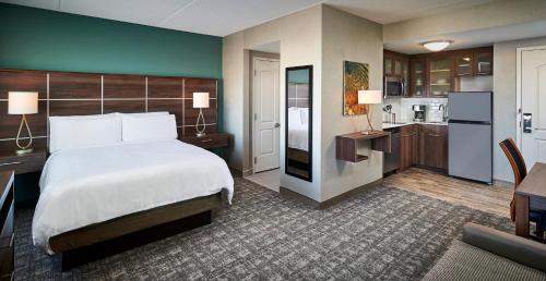 a hotel room with a bed and a kitchen at Staybridge Suites Niagara-On-The-Lake, an IHG Hotel in Niagara-on-the-Lake