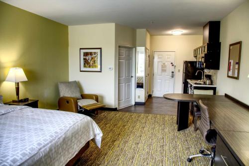 a hotel room with a bed and a desk at Candlewood Suites - Austin North by IHG in Austin