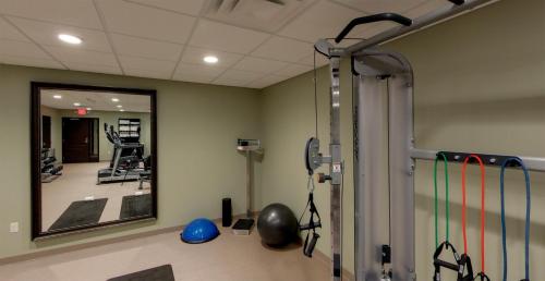 a gym with a mirror and some exercise equipment at Staybridge Suites Ann Arbor - Research Parkway by IHG in Ann Arbor