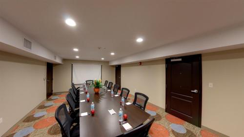 a conference room with a long table and chairs at Staybridge Suites Ann Arbor - Research Parkway by IHG in Ann Arbor