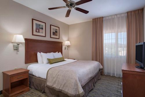 a hotel room with a bed and a flat screen tv at Candlewood Suites Austin North-Cedar Park, an IHG Hotel in Cedar Park