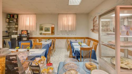 jadalnia z niebieskimi stołami i krzesłami w obiekcie Hotel Washington w Rzymie