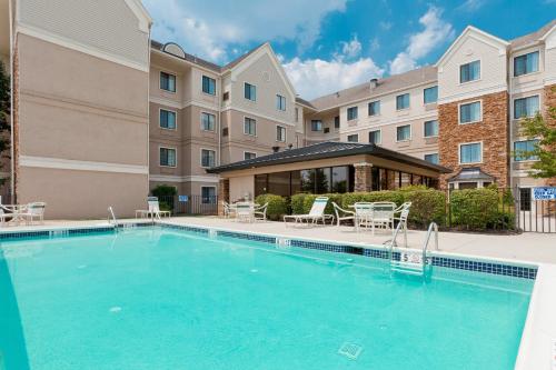 a swimming pool in front of a building at Staybridge Suites Allentown Airport Lehigh Valley by IHG in Allentown