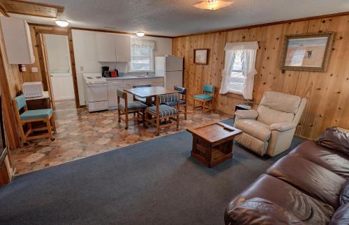 a living room with a couch and a table at Outer Banks Motel - Village Accommodations in Buxton