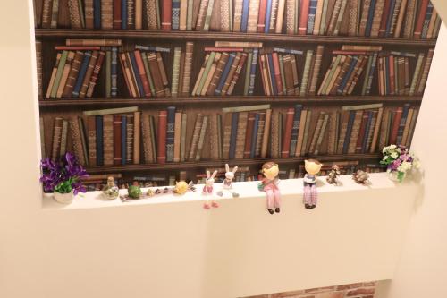 a shelf with some figurines and books on it at Yu Shou Hao Hsien Guesthouse in Fushi