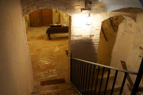 a hallway with a staircase with a stone wall at Cal Gorro in Arnés