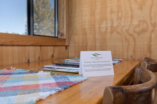 a wooden table with a sign on top of it at Sierra Meadows Ranch in Mammoth Lakes