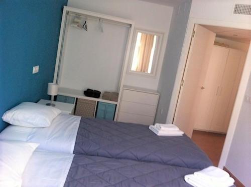 a bedroom with a large bed and a window at Corazón de Nervión, excelente ubicación, opcion PARKING in Seville