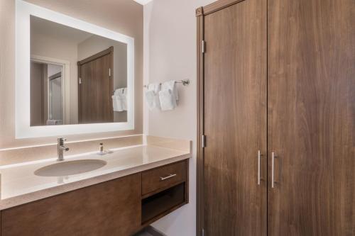 a bathroom with a sink and a mirror at Staybridge Suites Anchorage by IHG in Anchorage