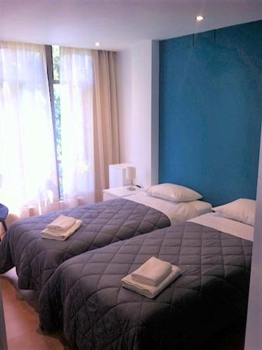 a bedroom with two beds with towels on them at Corazón de Nervión, excelente ubicación, opcion PARKING in Seville