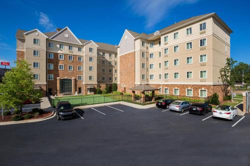a large building with cars parked in a parking lot at Staybridge Suites Augusta by IHG in Augusta
