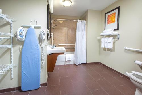 a bathroom with a shower and a sink and a toilet at Staybridge Suites Augusta, an IHG Hotel in Augusta