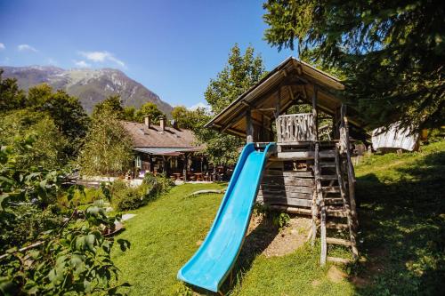a blue slide in the yard of a house at Guest House Kraljev Hrib in Kamniška Bistrica