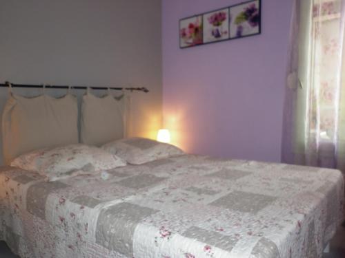 une chambre avec un lit avec une couette blanche dans l'établissement Appartement 2 Pièces Vue Mer Rochelongue CAP D'AGDE, au Cap d'Agde